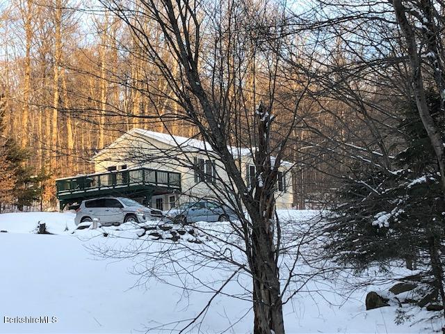 125 Middlefield Road Peru, MA 01235 - Photo 1 of 45 a white house that has a tree in the background