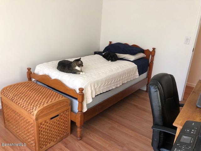 125 Middlefield Road Peru, MA 01235 - Photo 21 of 45 a bedroom with a bed and wooden floor