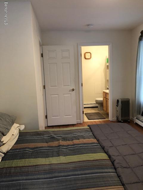 125 Middlefield Road Peru, MA 01235 - Photo 27 of 45 a bedroom with a bed and wooden floor