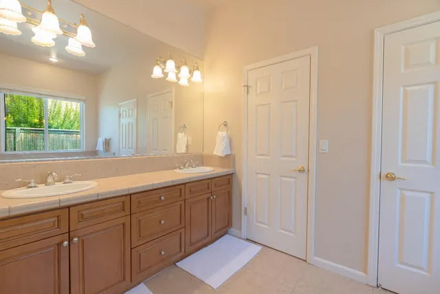 a bathroom with a double vanity sink and a mirror