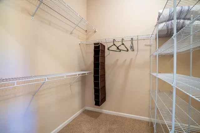 a view of walk in closet with clothes