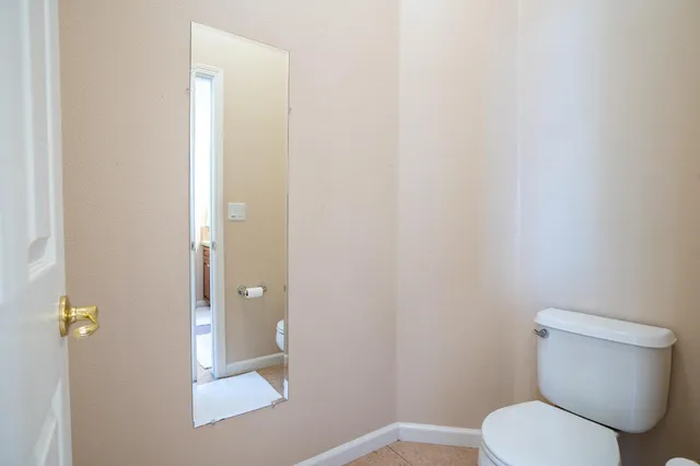 a white toilet sitting next to a shower