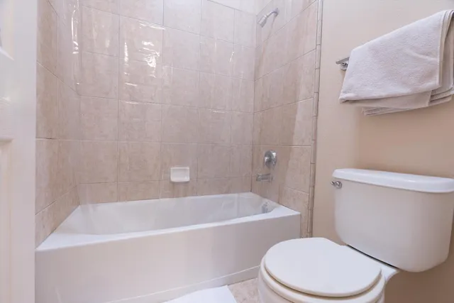 a white bath tub sitting next to a white toilet