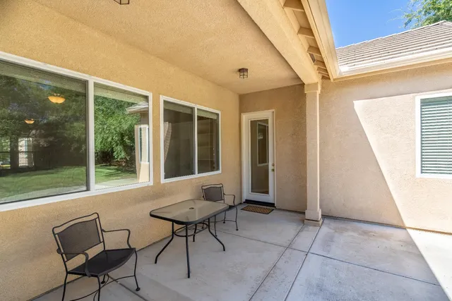 a view of an outdoor space with furniture and front door