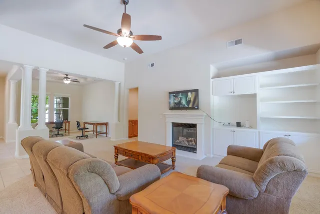 a living room with furniture and a fireplace
