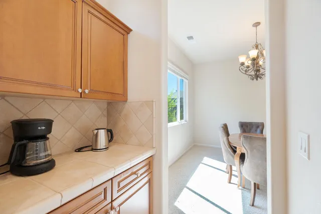 a view of a room with wooden floor and cabinets