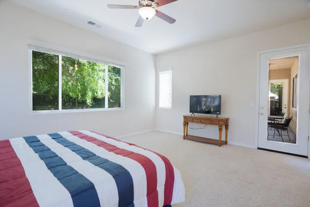 a bedroom with a bed and a television