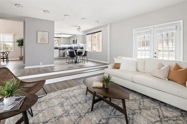 a living room with furniture and wooden floor