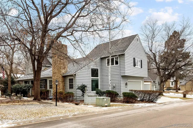 a view of a house with a yard covered in snow