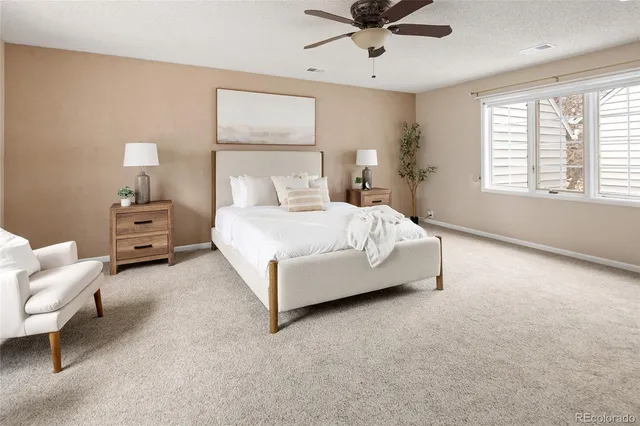 a bedroom with a bed couch and window