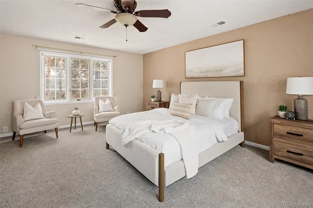 a bedroom with a bed and a couch