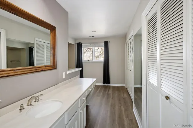 a spacious bathroom with a tub sink and mirror