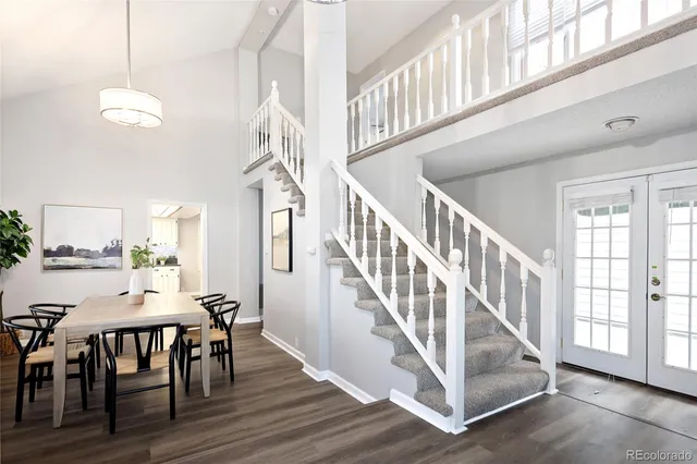 a view of entryway and dining room with wooden floor