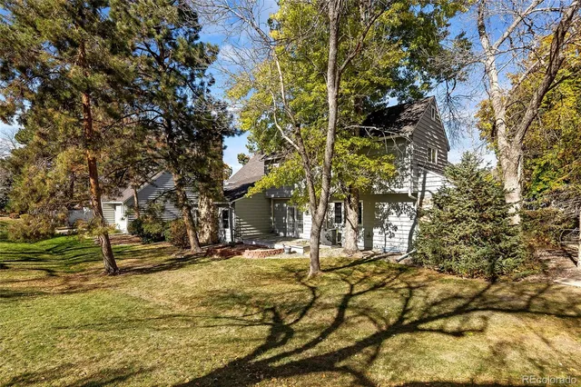 a view of a yard with wooden fence