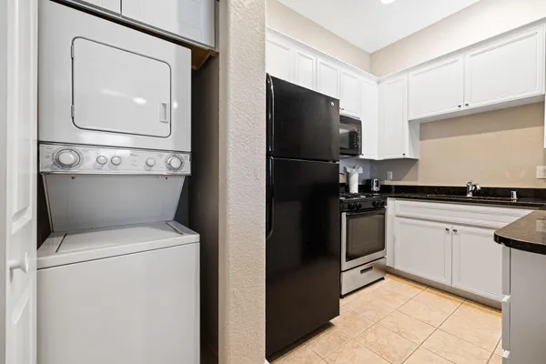 a kitchen with a refrigerator and a stove top oven