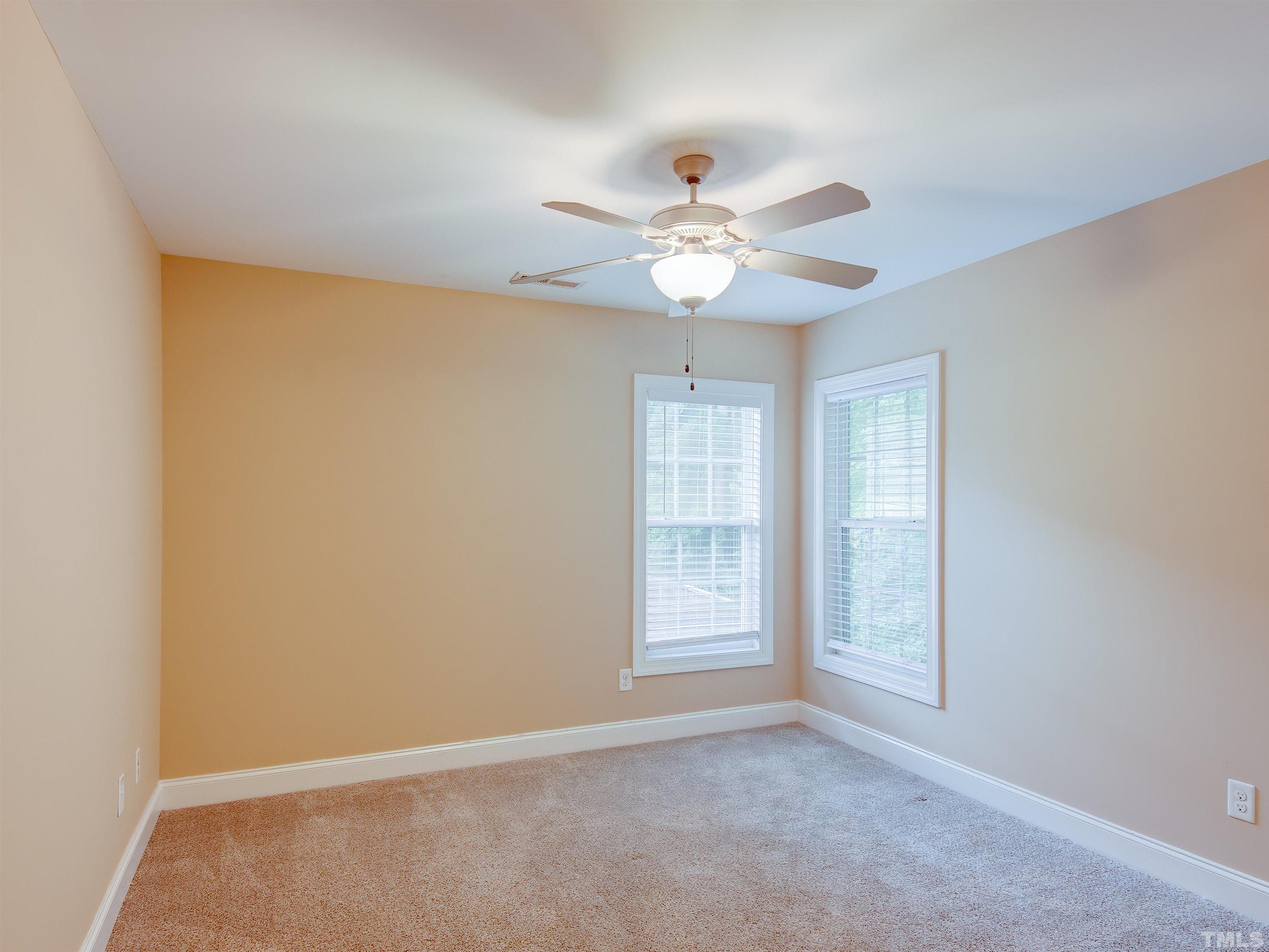 1104 Kingston Ridge Road Cary, NC 27511 - Photo 22 of 26 an empty room with windows and fan