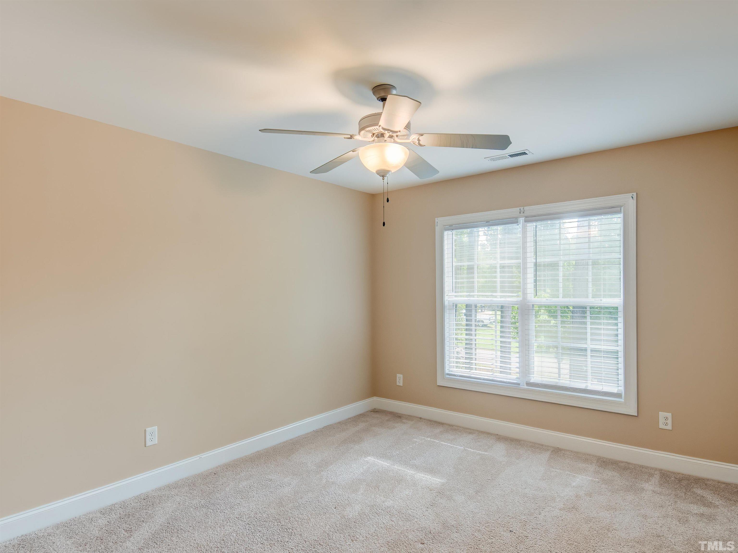 1104 Kingston Ridge Road Cary, NC 27511 - Photo 23 of 26 an empty room with a window and a ceiling fan