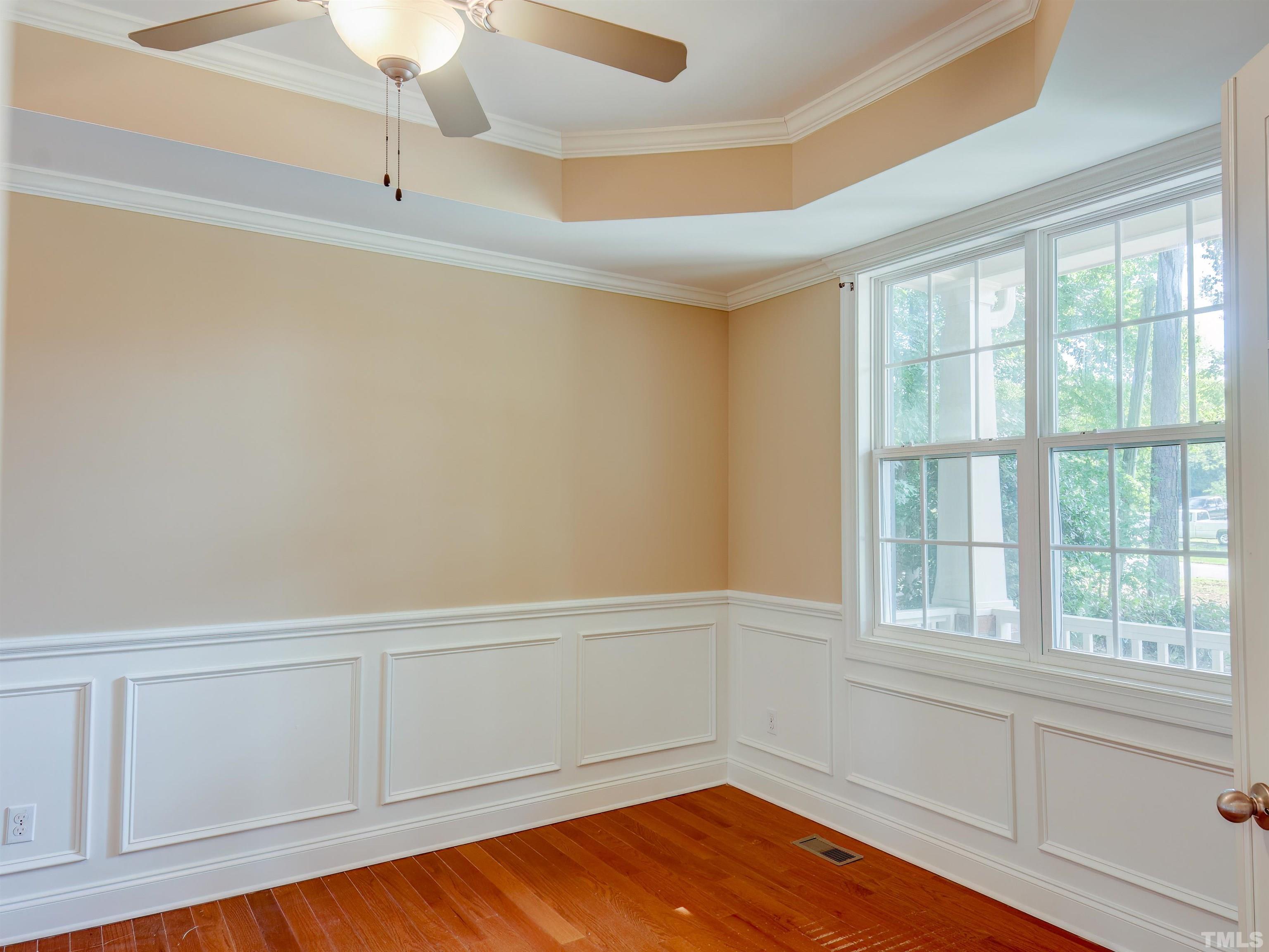 1104 Kingston Ridge Road Cary, NC 27511 - Photo 6 of 26 a view of an empty room with wooden floor and a window