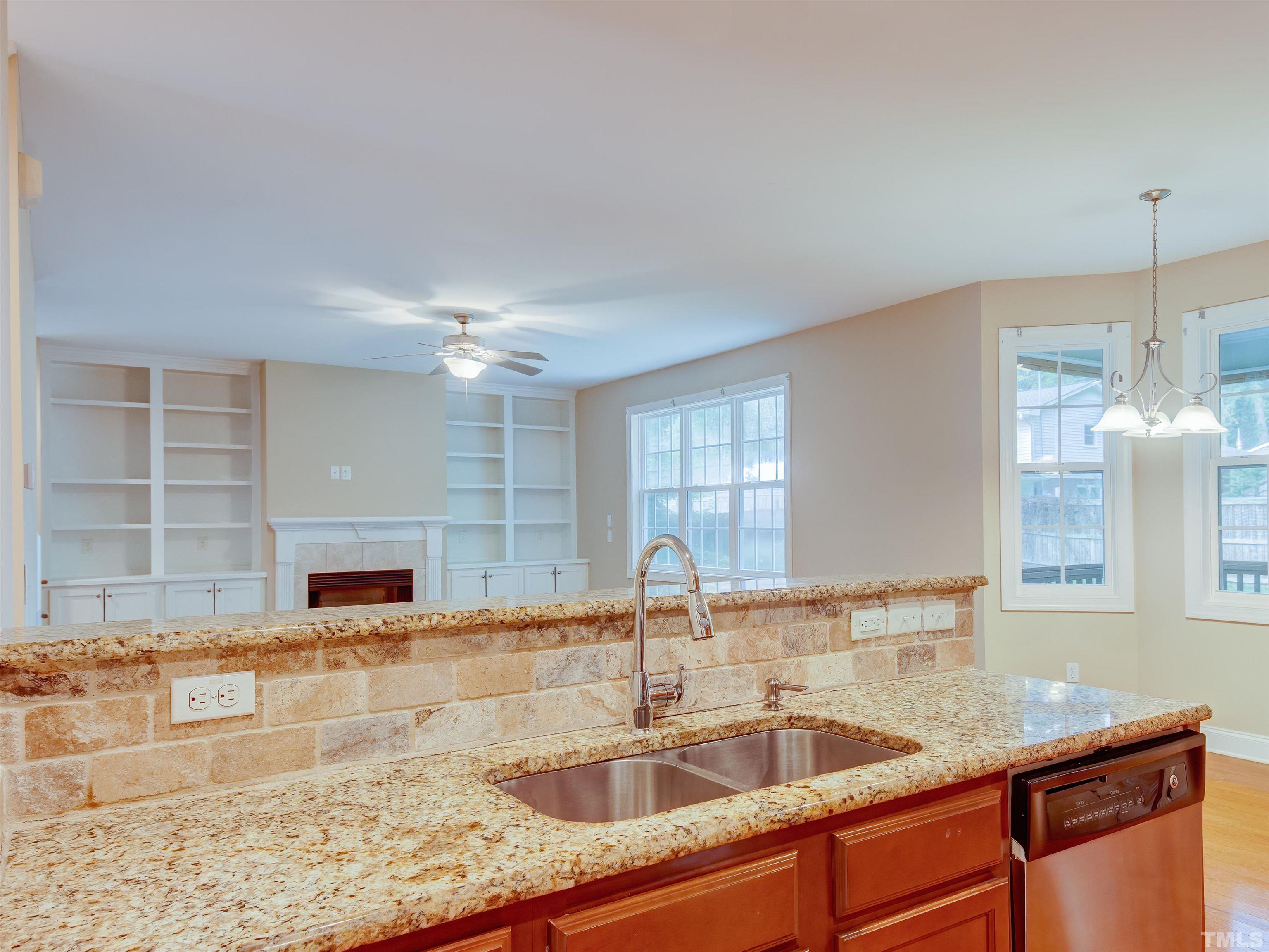1104 Kingston Ridge Road Cary, NC 27511 - Photo 8 of 26 a kitchen with granite countertop a sink and a window