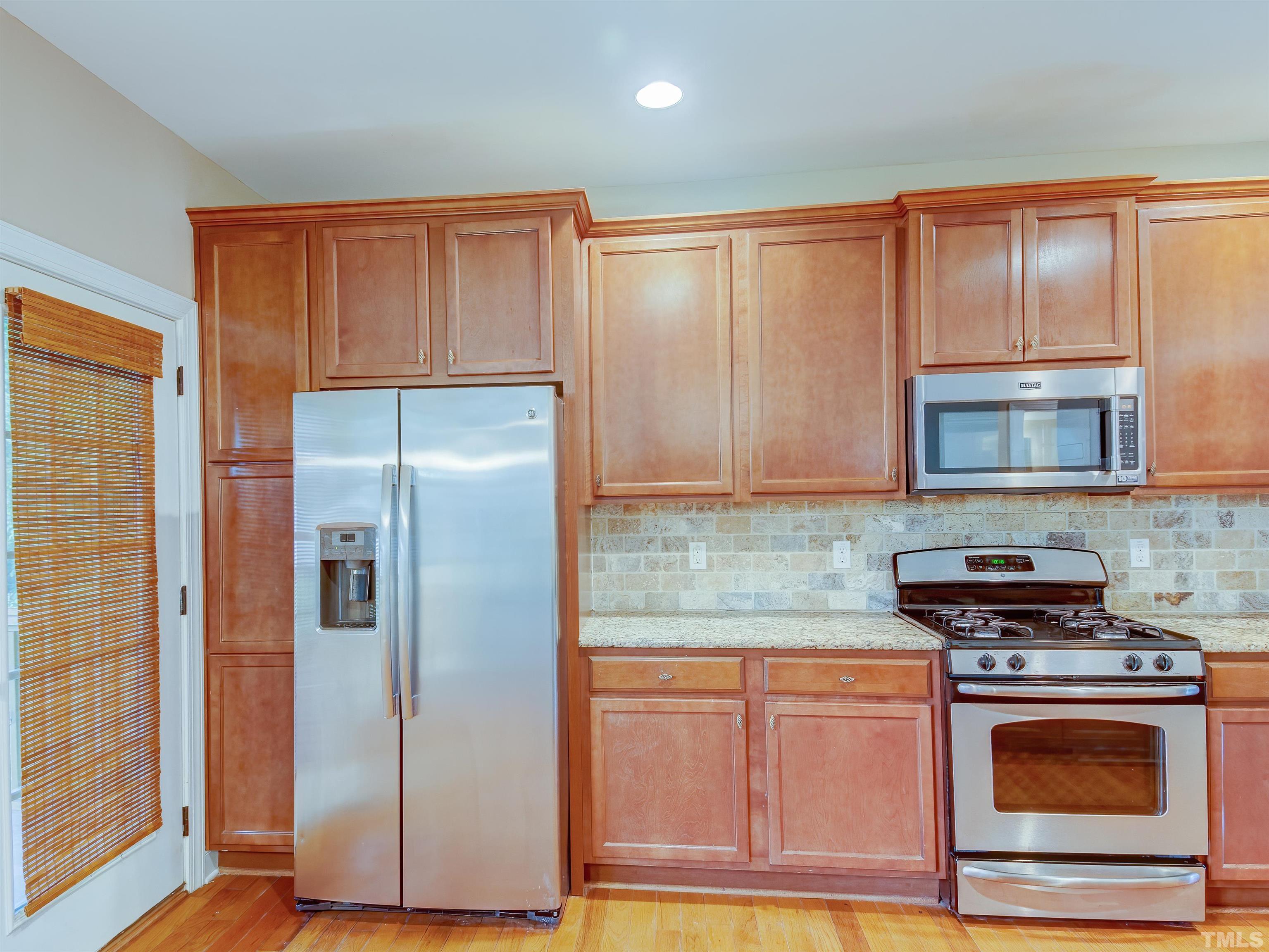 1104 Kingston Ridge Road Cary, NC 27511 - Photo 10 of 26 a kitchen with stainless steel appliances granite countertop a refrigerator stove and sink