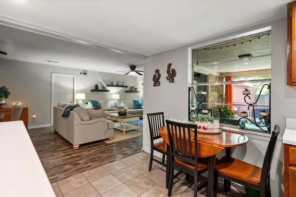 a dining room with furniture and wooden floor
