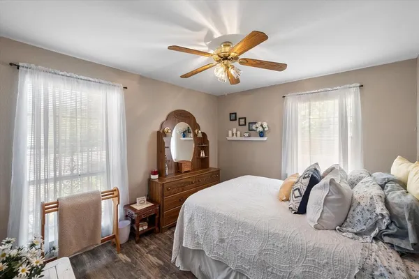 a bedroom with a large bed and a large window