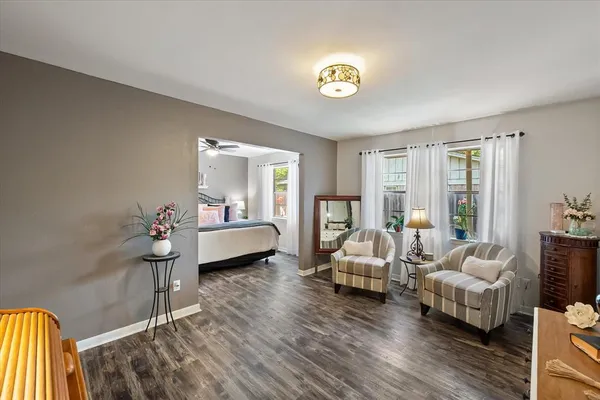 a bedroom with furniture and a wooden floor