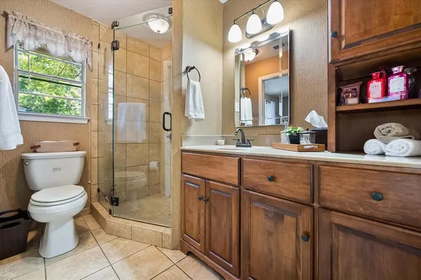 a bathroom with a toilet sink and shower