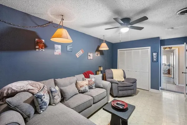 a living room with furniture and a lamp