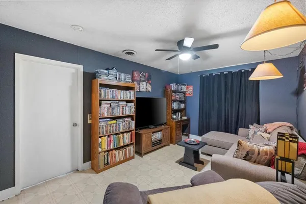 a living room with furniture a lamp and a window