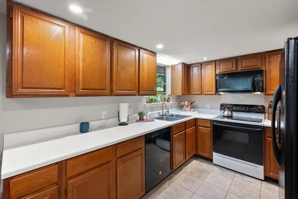 a kitchen with a sink stove and microwave