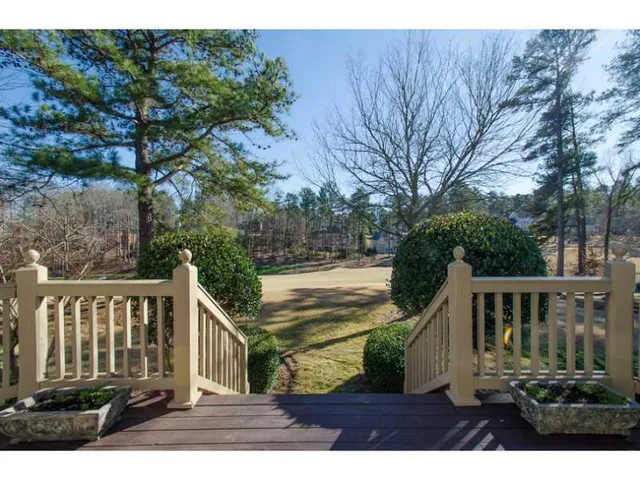 a view of house with backyard and trees