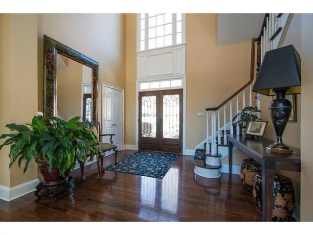 a view of entryway and hall with wooden floor