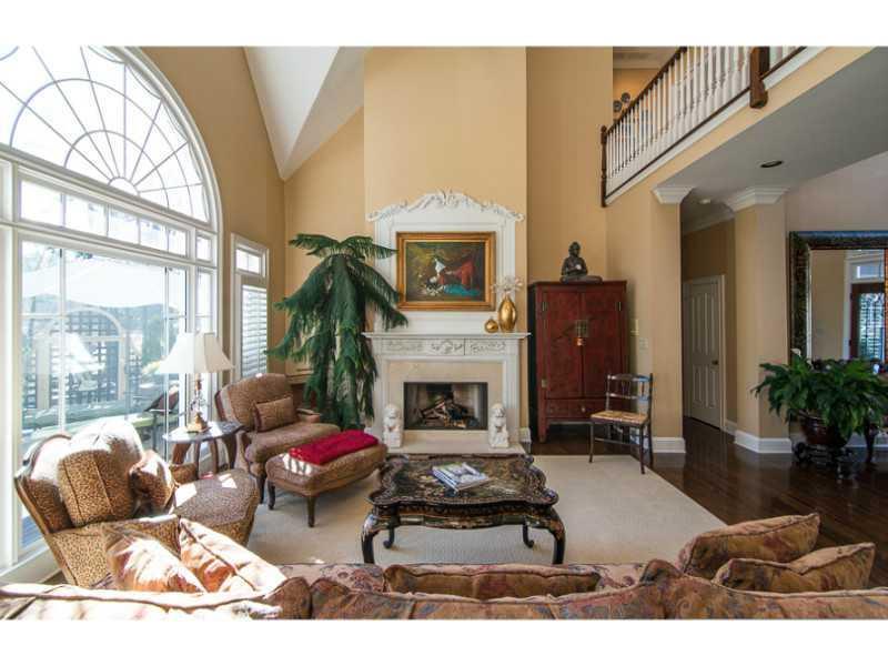 40 Dover Cliff Way Alpharetta, GA 30022 - Photo 5 of 24 a living room with furniture a fireplace and a floor to ceiling window