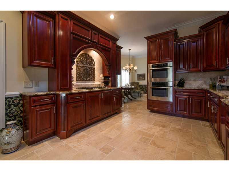 40 Dover Cliff Way Alpharetta, GA 30022 - Photo 6 of 24 a kitchen with granite countertop a stove a sink and a microwave