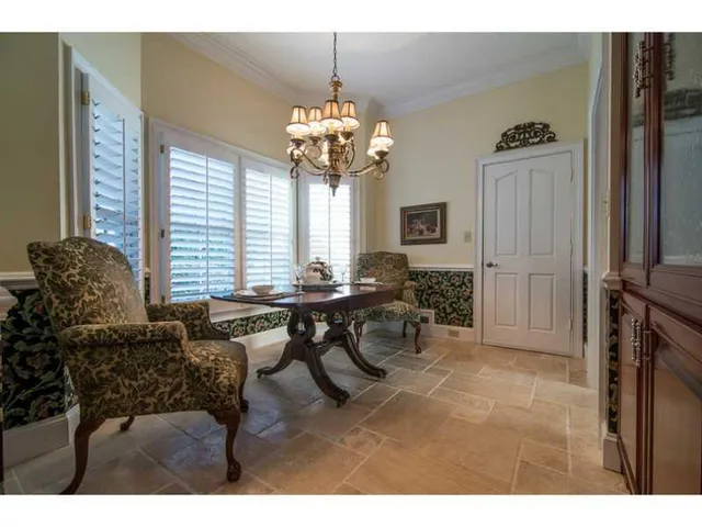 a living room with furniture a window and a chandelier