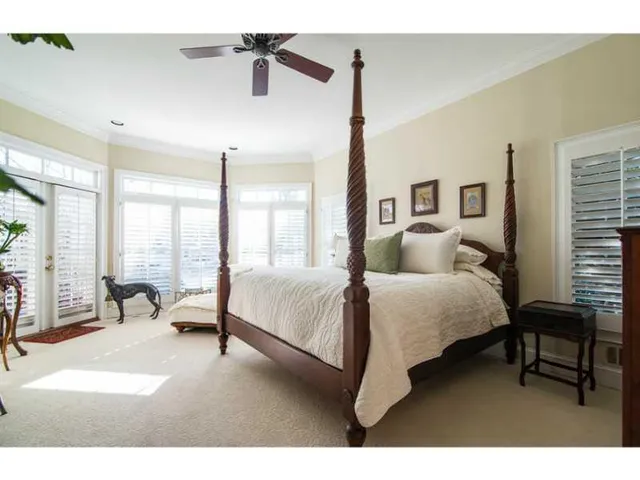 a bed room with a bed and a chair