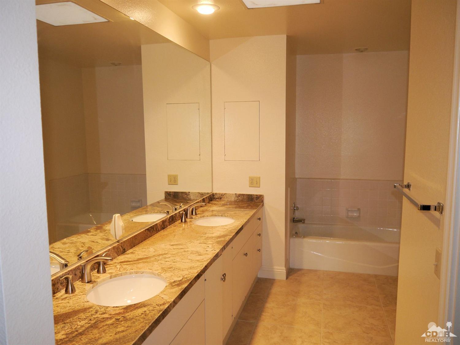 46330 Dove Road Indian Wells, CA 92210 - Photo 13 of 25 a bathroom with a granite countertop sink and a mirror