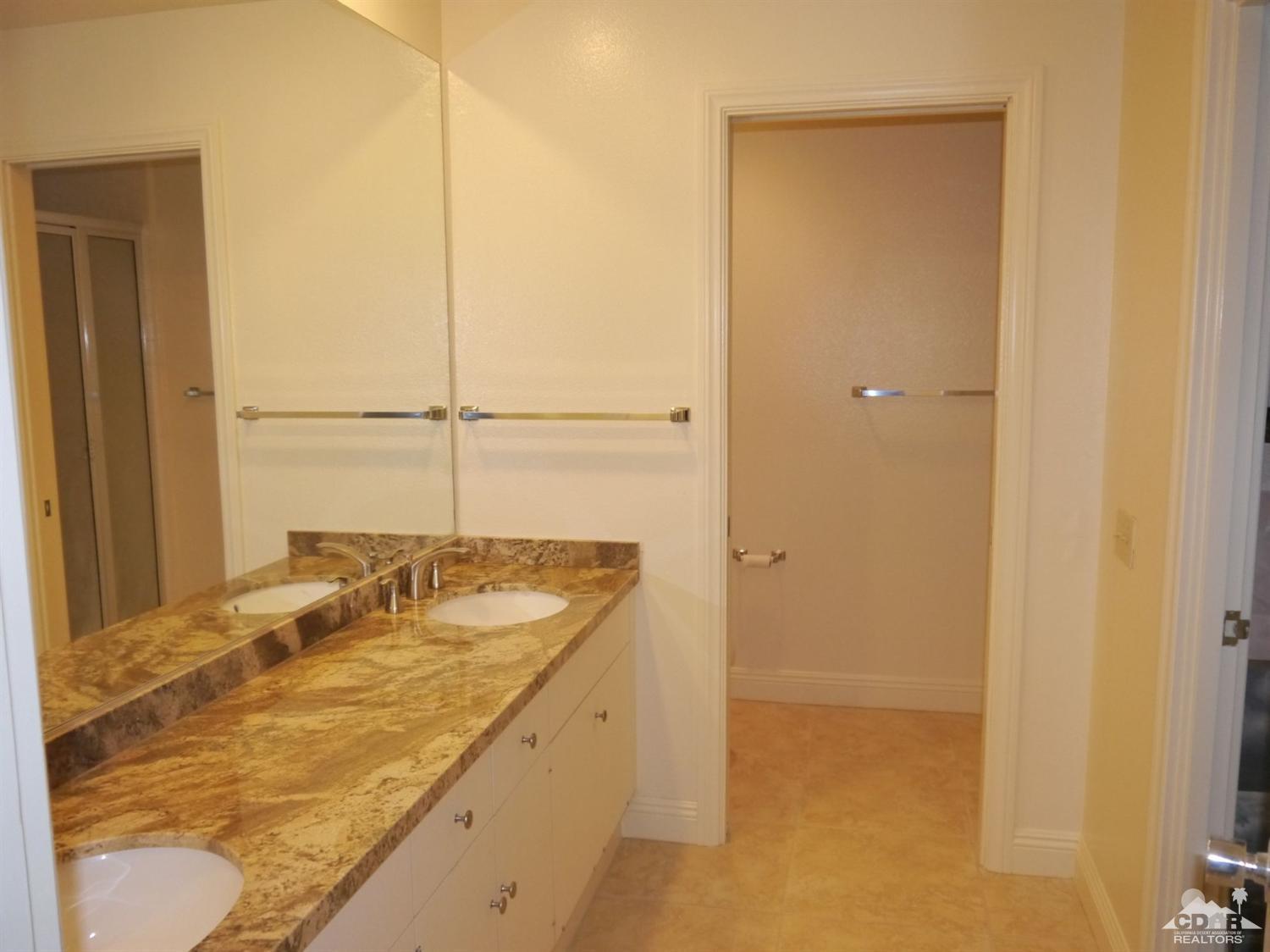 46330 Dove Road Indian Wells, CA 92210 - Photo 16 of 25 a bathroom with a granite countertop sink and a mirror