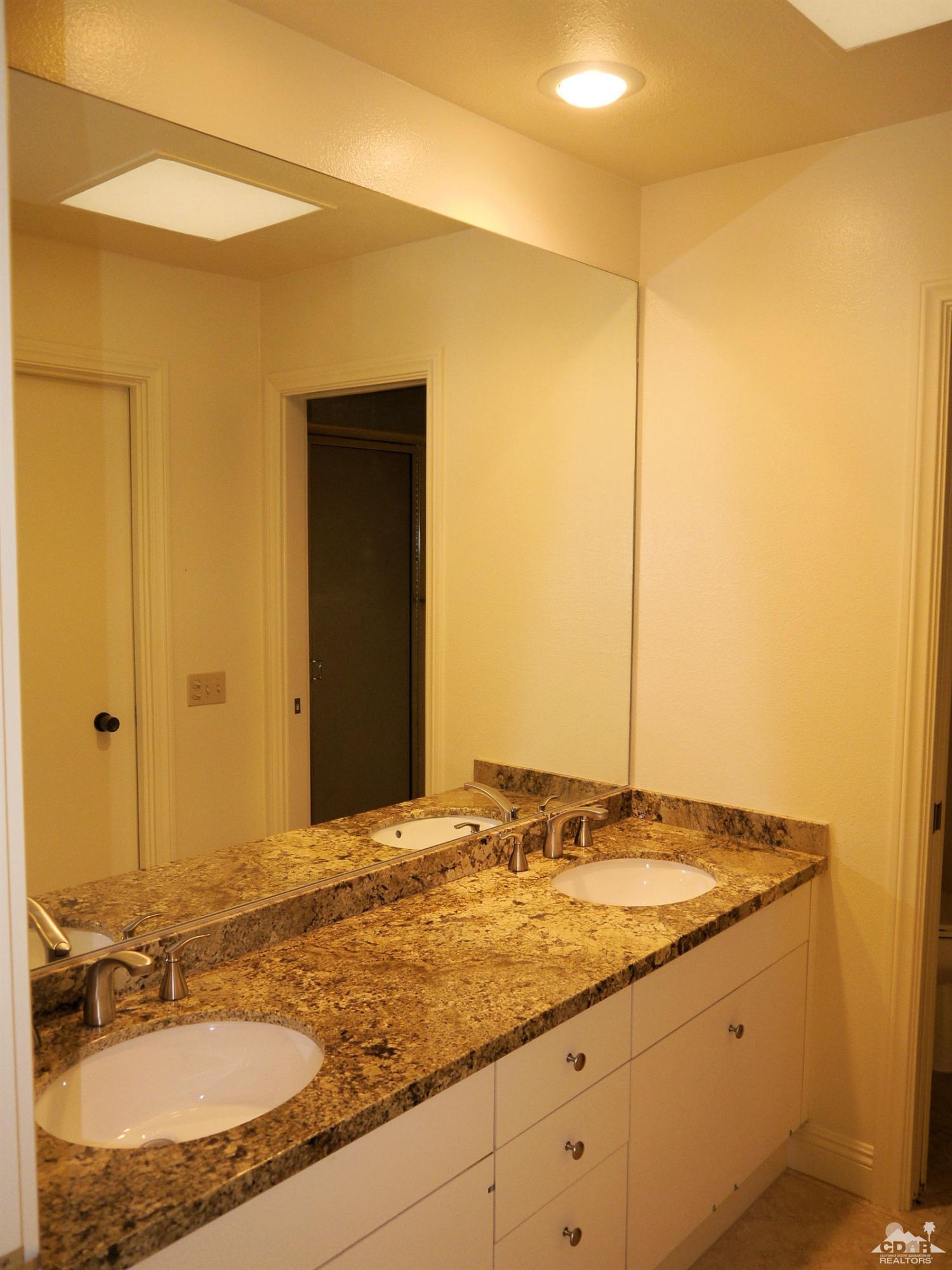 46330 Dove Road Indian Wells, CA 92210 - Photo 19 of 25 a bathroom with a granite countertop sink and a mirror