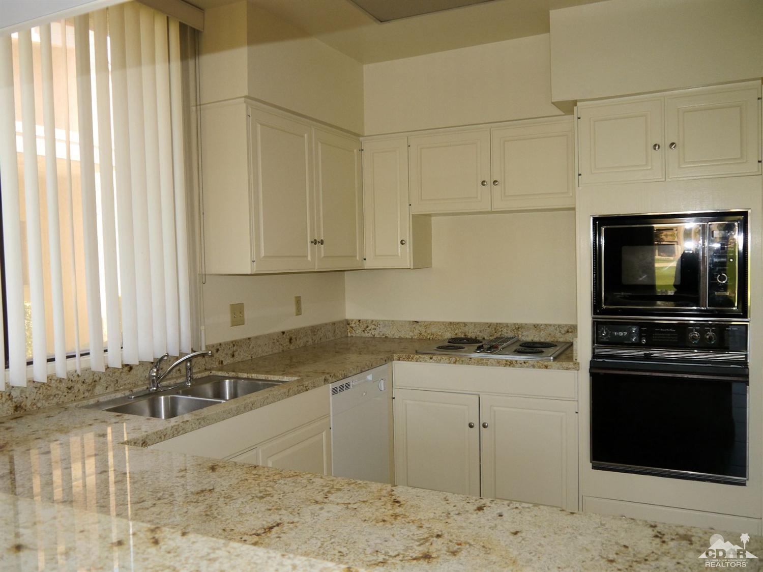 46330 Dove Road Indian Wells, CA 92210 - Photo 8 of 25 a kitchen with a stove a sink and a microwave