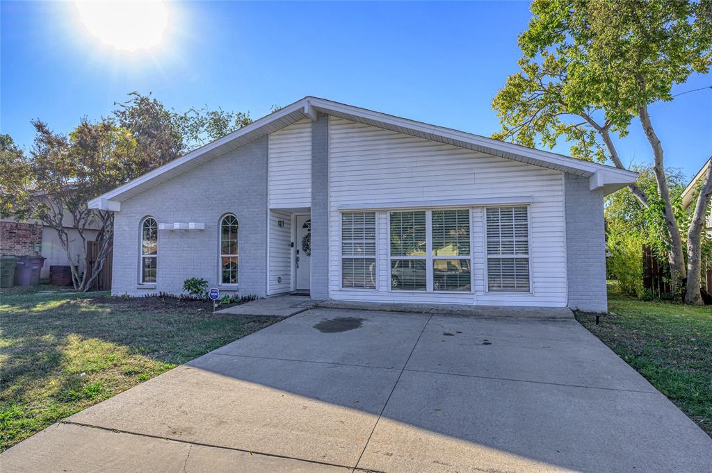 2038 Rose Hill Road Carrollton, TX 75007 - Photo 2 of 35 a front view of a house with a yard and garage