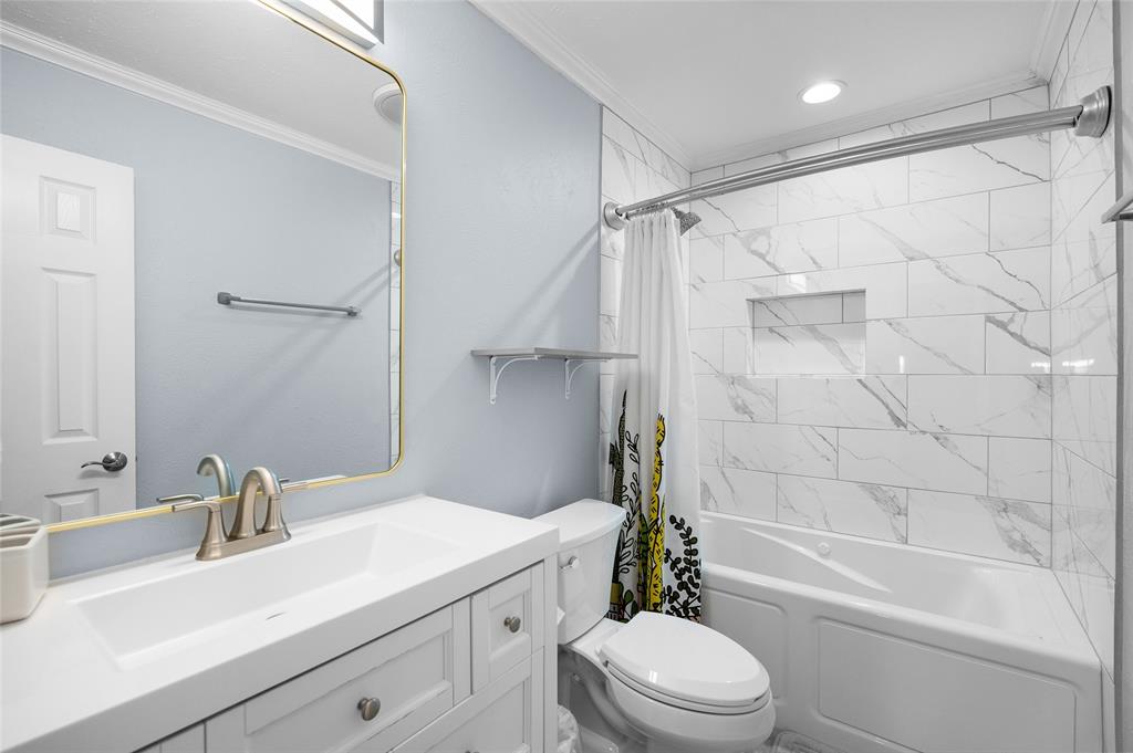 2038 Rose Hill Road Carrollton, TX 75007 - Photo 21 of 35 a bathroom with a sink toilet and shower