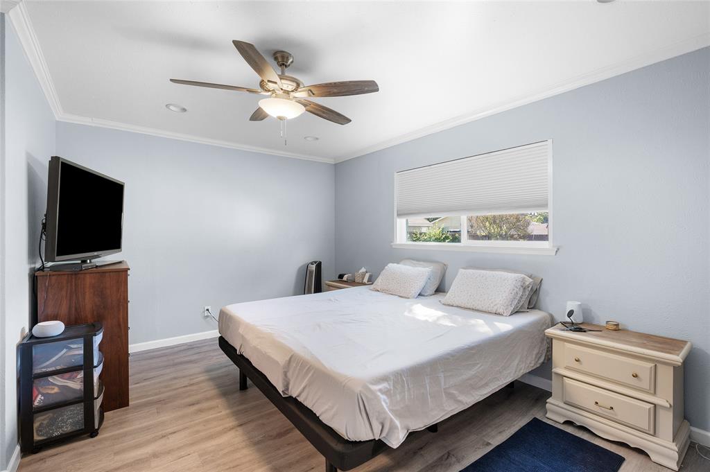 2038 Rose Hill Road Carrollton, TX 75007 - Photo 23 of 35 a bedroom with a bed and a flat screen tv