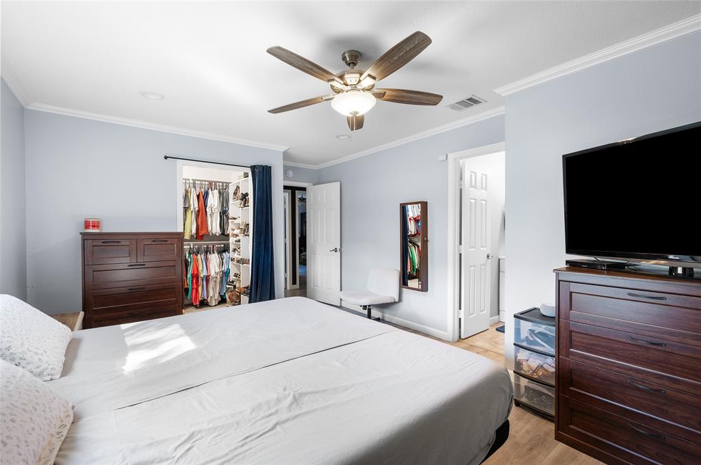 2038 Rose Hill Road Carrollton, TX 75007 - Photo 24 of 35 a bedroom with a bed and a flat screen tv