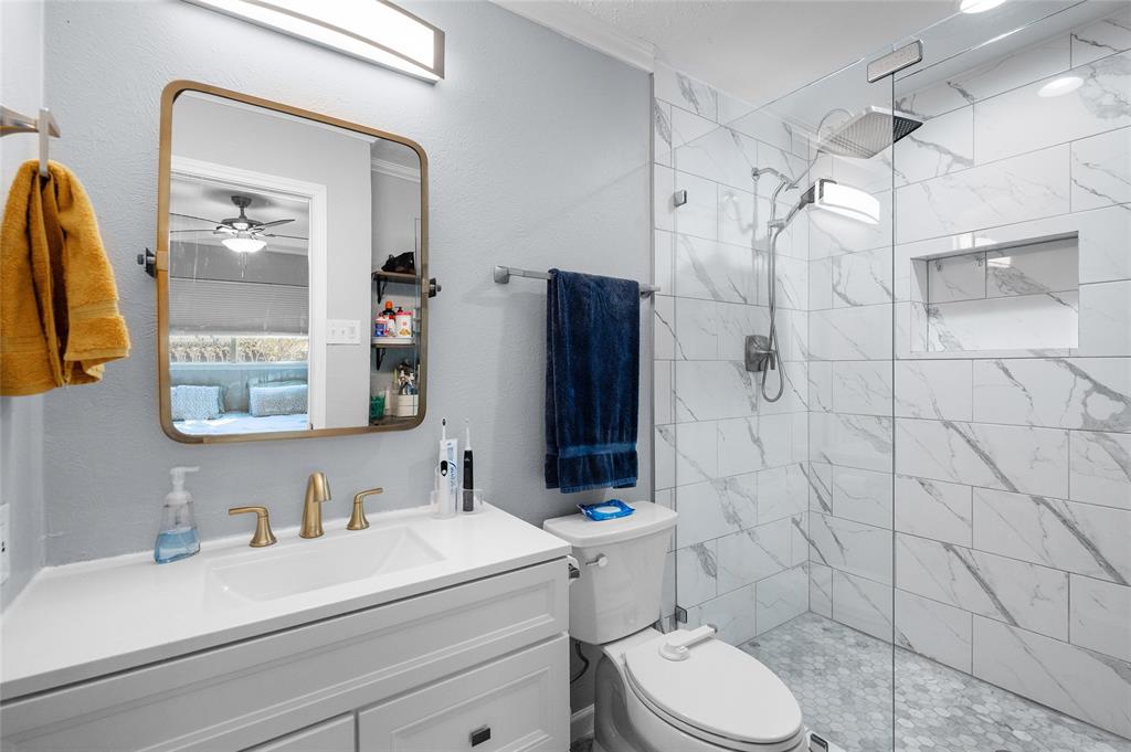 2038 Rose Hill Road Carrollton, TX 75007 - Photo 25 of 35 a bathroom with a sink vanity mirror and toilet