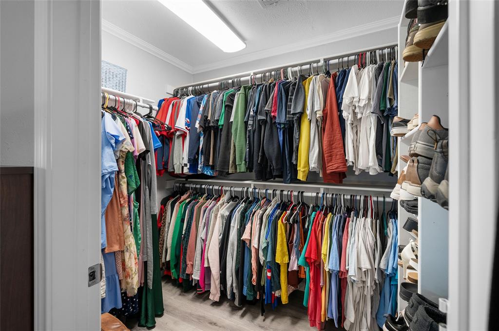 2038 Rose Hill Road Carrollton, TX 75007 - Photo 26 of 35 a view of walk in closet with clothes