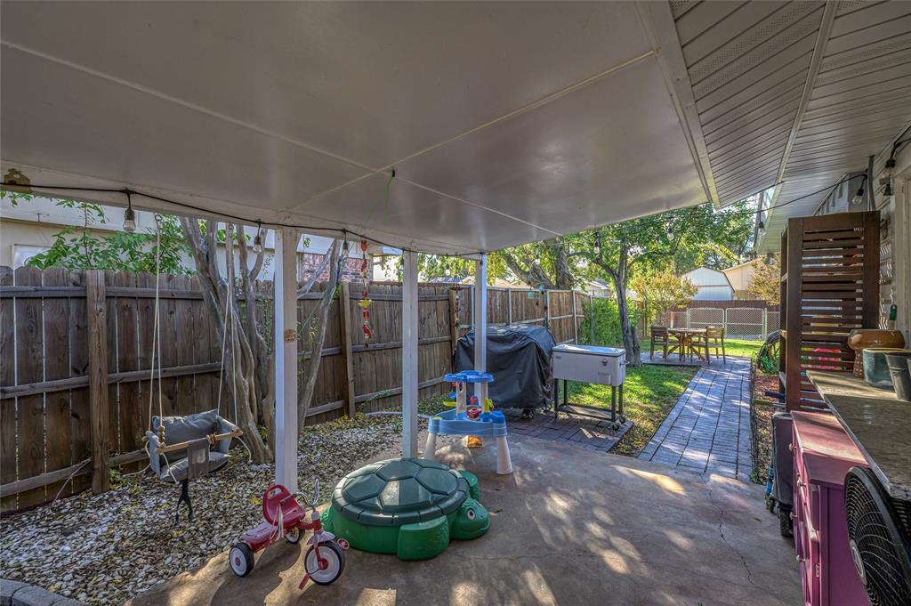 2038 Rose Hill Road Carrollton, TX 75007 - Photo 27 of 35 a view of a chairs and table in backyard