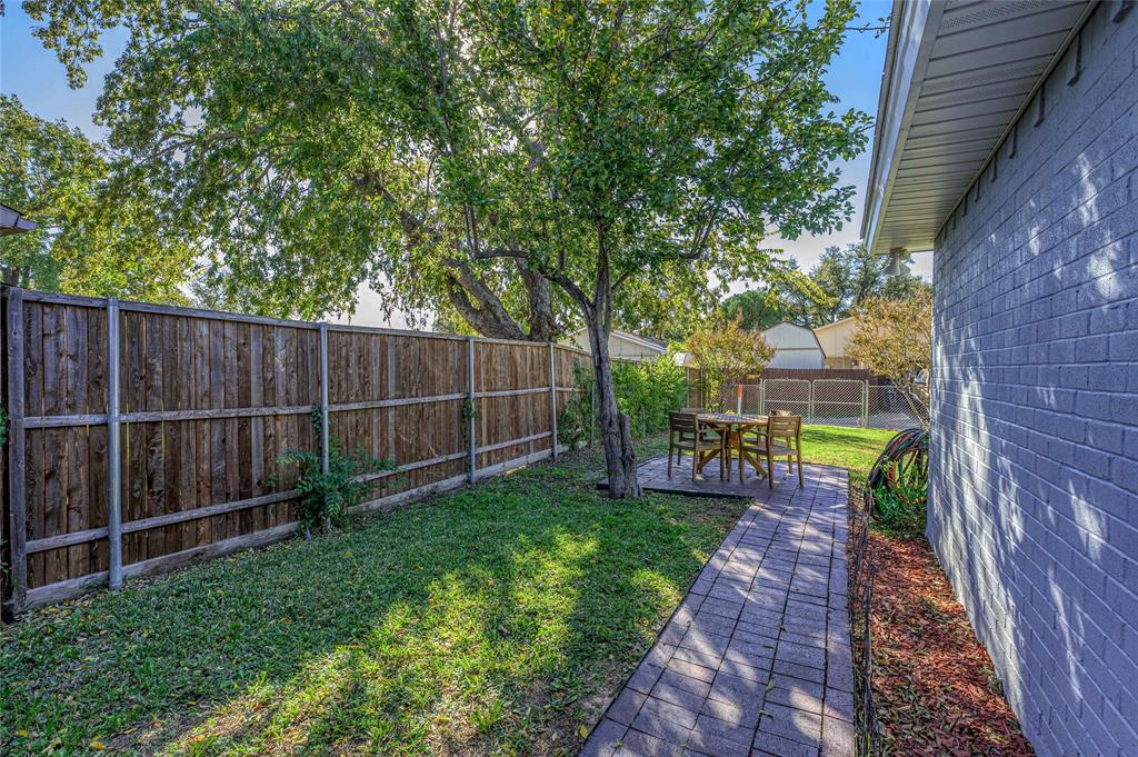 2038 Rose Hill Road Carrollton, TX 75007 - Photo 28 of 35 a view of a backyard with a garden