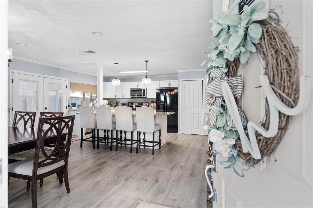 2038 Rose Hill Road Carrollton, TX 75007 - Photo 3 of 35 a view of a dining room with furniture and wooden floor